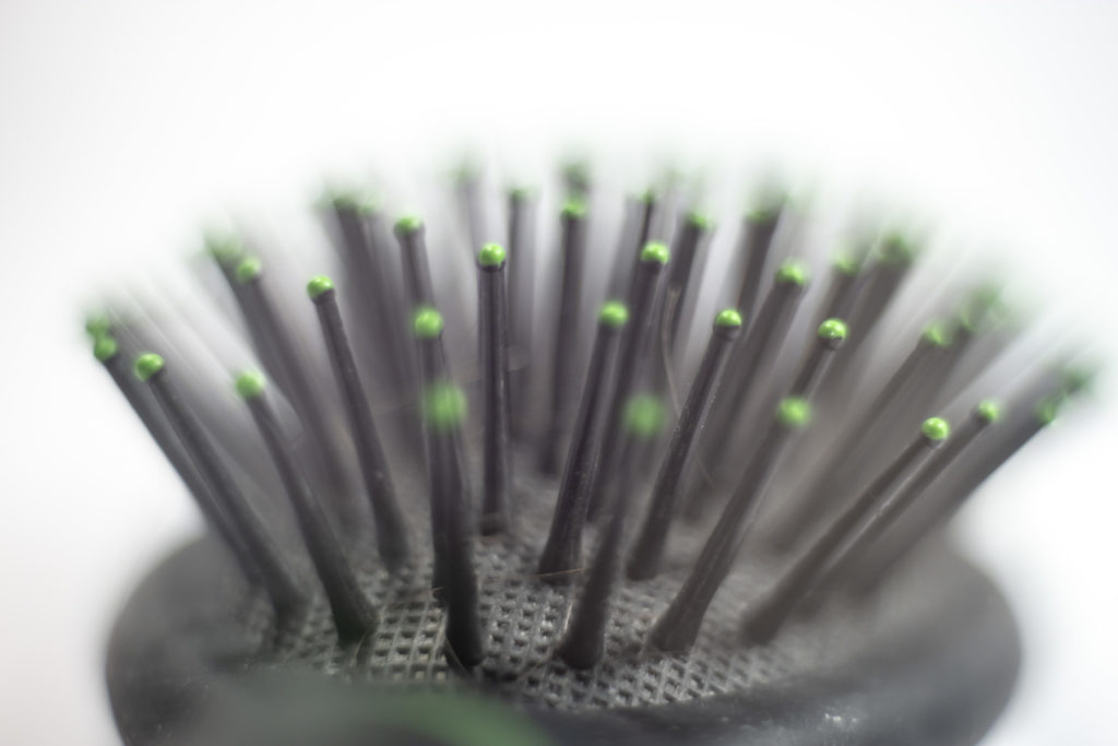 black spikes and green tips of the hair brush