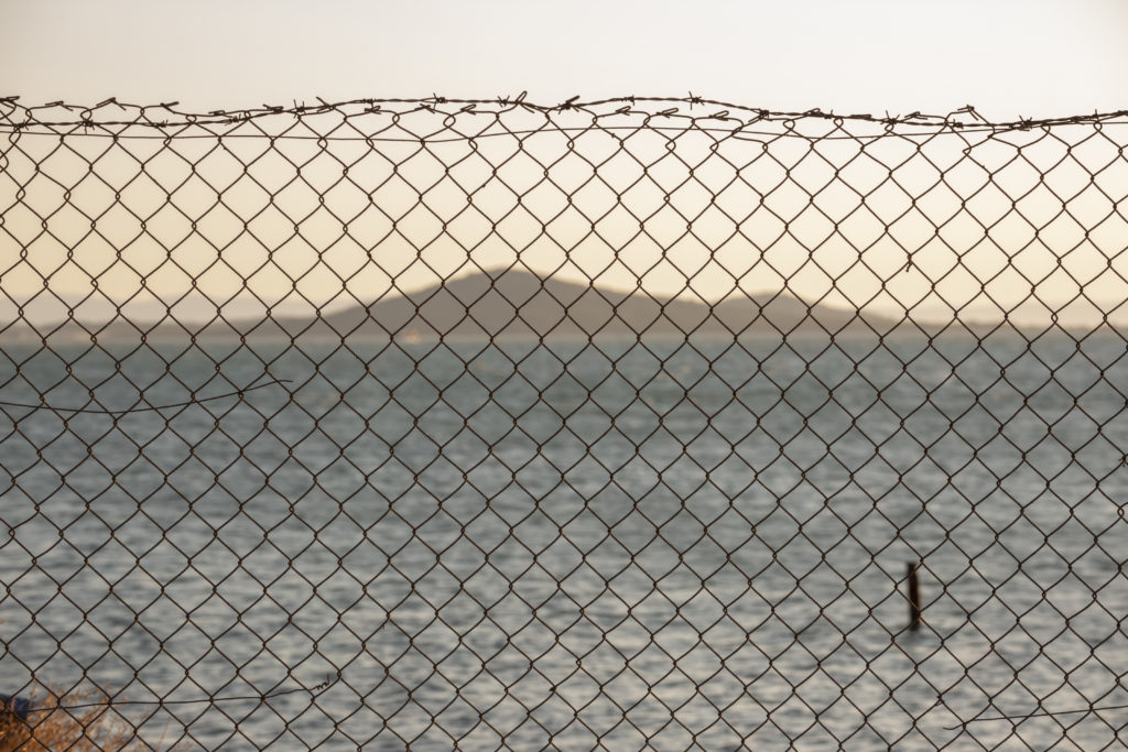 sea and island behind the wire fences